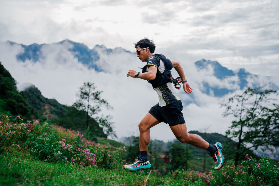 Athlète en plein sprint de nuit sur une piste balisée